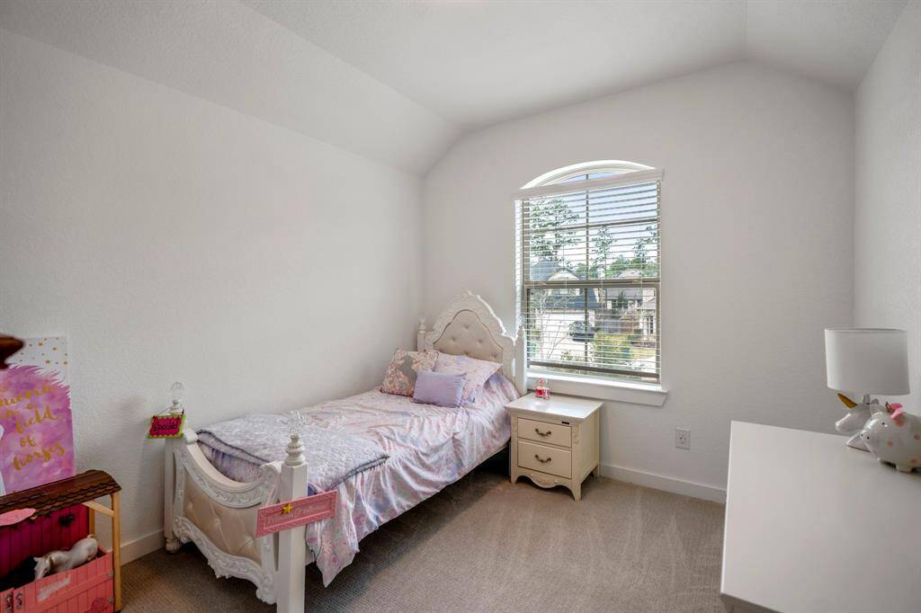 This view inside the bedroom just off the loft space showcases a comfortable and private retreat. With ample natural light, the room feels bright and airy, making it an ideal space for relaxation. The design allows for flexibility, whether used as a guest room, home office, or personal sanctuary. The nearby bathroom and the open layout of the second floor provide added convenience and accessibility.