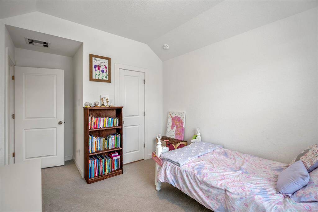 This additional view of the bedroom highlights the spacious layout and the door leading to the large closet, offering plenty of storage space. The room’s natural light and functional design make it a versatile space, perfect for a variety of uses. With easy access to the bathroom and the loft area nearby, it’s a great option for comfort and convenience.
