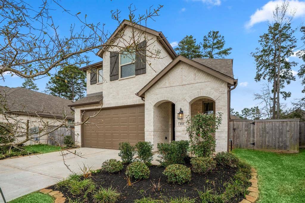 The beautifully landscaped front yard enhances the home's curb appeal, while the striking double arches over the front porch create a welcoming entrance. Thoughtful exterior details add to the home's charm and character.