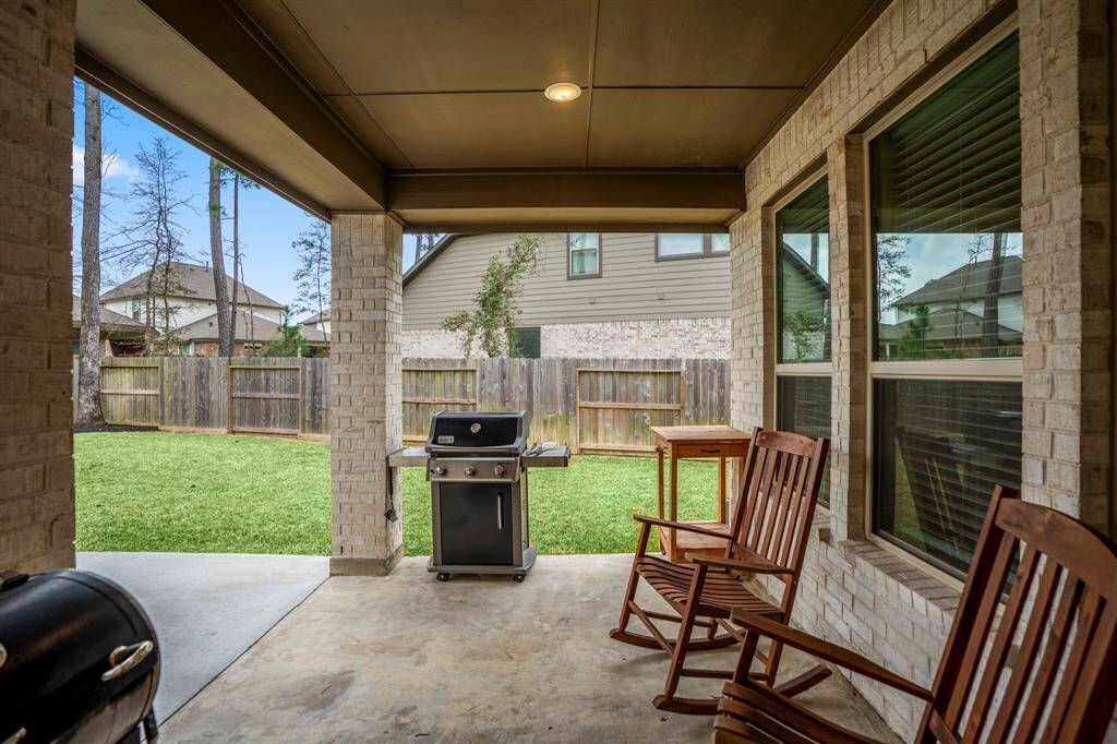 Stepping outside onto the back porch, you'll find a spacious and inviting area, perfect for relaxing or entertaining. The extended covered patio offers plenty of room for outdoor seating, and the large backyard beyond provides a private retreat. Whether enjoying morning coffee or hosting a gathering, this outdoor space enhances the home’s living experience.