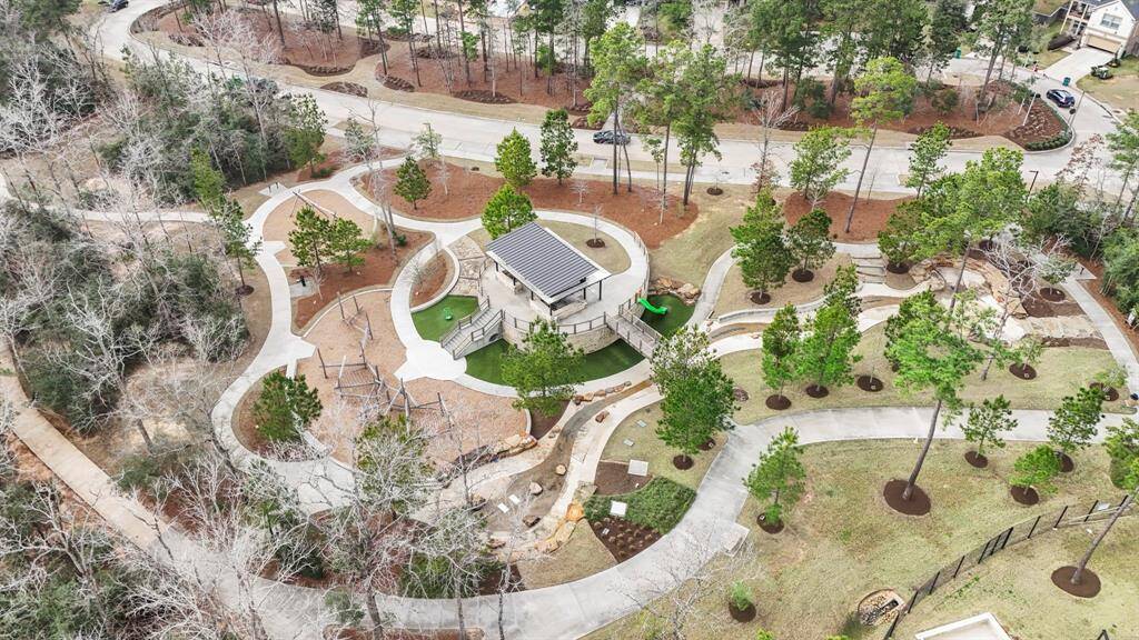 This shot highlights one of the many parks in The Woodlands Hills, complete with a shaded pavilion and scenic walking trails. Ideal for enjoying the outdoors, this space offers a peaceful retreat for residents, whether for a stroll, picnics, or just relaxing in nature. The well-maintained trails and community amenities enhance the outdoor living experience, making this park a central feature of the neighborhood.