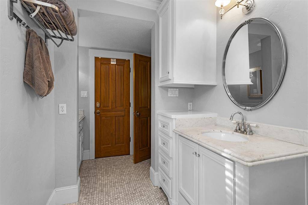 The primary closet is found off the primary bathroom with built-in dressers.