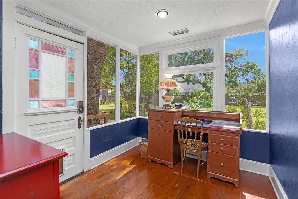 At the back of the home is this beautiful sun room/office. The stained glass door is original to the home. Truly one of a kind!
