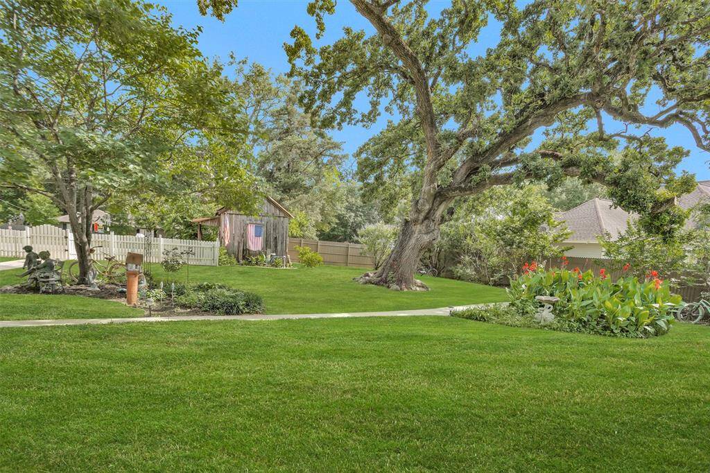 The unbelievable 180+ year old pecan tree makes this backyard spectacular.