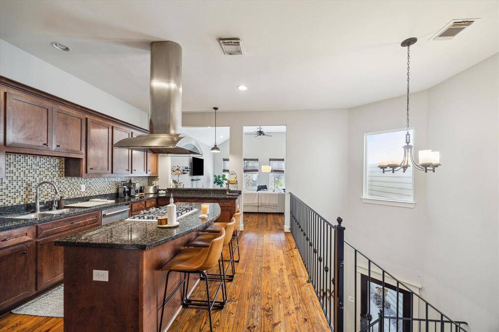 Spacious kitchen featuring a stylish island with a built-in cooktop.