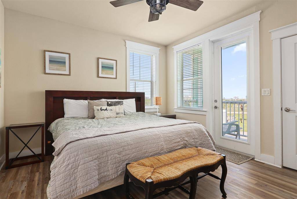 Discover the serene comfort of this primary bedroom, adorned with calming tones and large windows that allow natural light to fill the space. The king-sized bed invites you to relax and unwind.