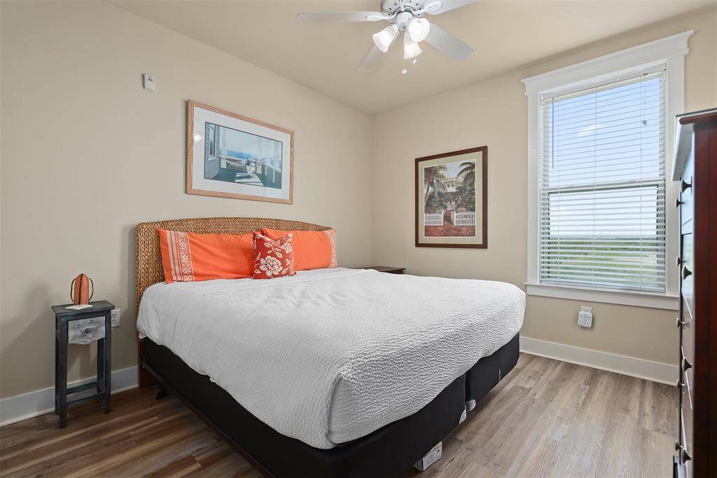Step into this delightful guest bedroom, where subtle colors and coastal decor create a cheerful and inviting atmosphere. The room features a comfortable bed with a stylish wicker headboard and comfortable bedding that adds a pop of personality.