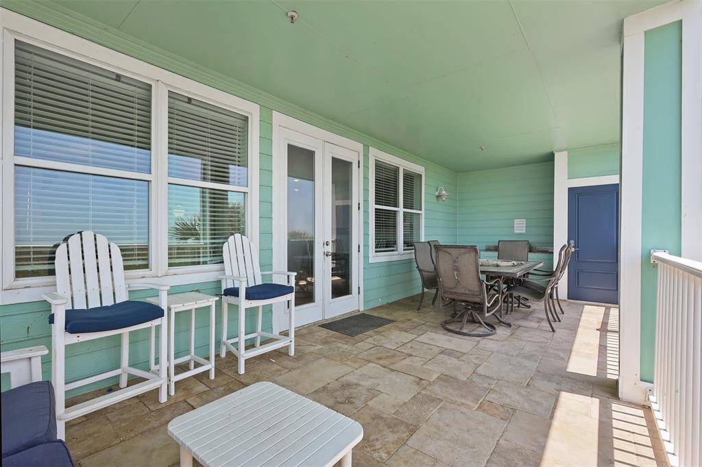 Enjoy the ultimate outdoor living experience on this spacious covered patio, perfect for dining and relaxation. With ample seating, including a cozy outdoor couch and a dining table set for al fresco meals, this patio is designed for entertaining and unwinding amidst the ocean breeze.