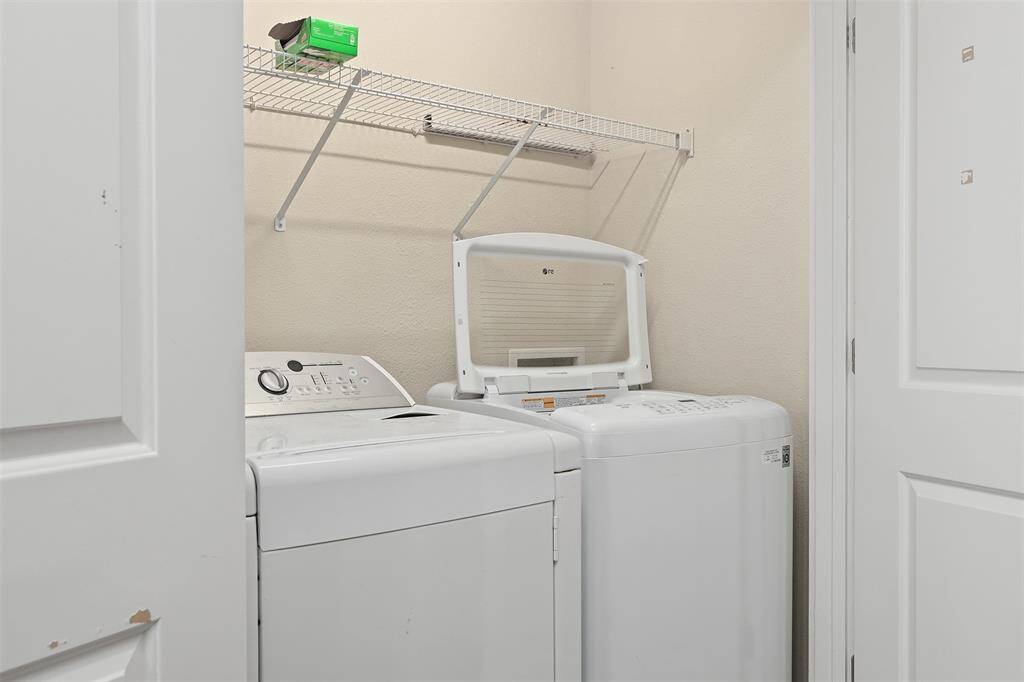 Convenience meets efficiency in this well-appointed laundry room, complete with modern washer and dryer, and ample shelving providing organized storage for all your laundry essentials.