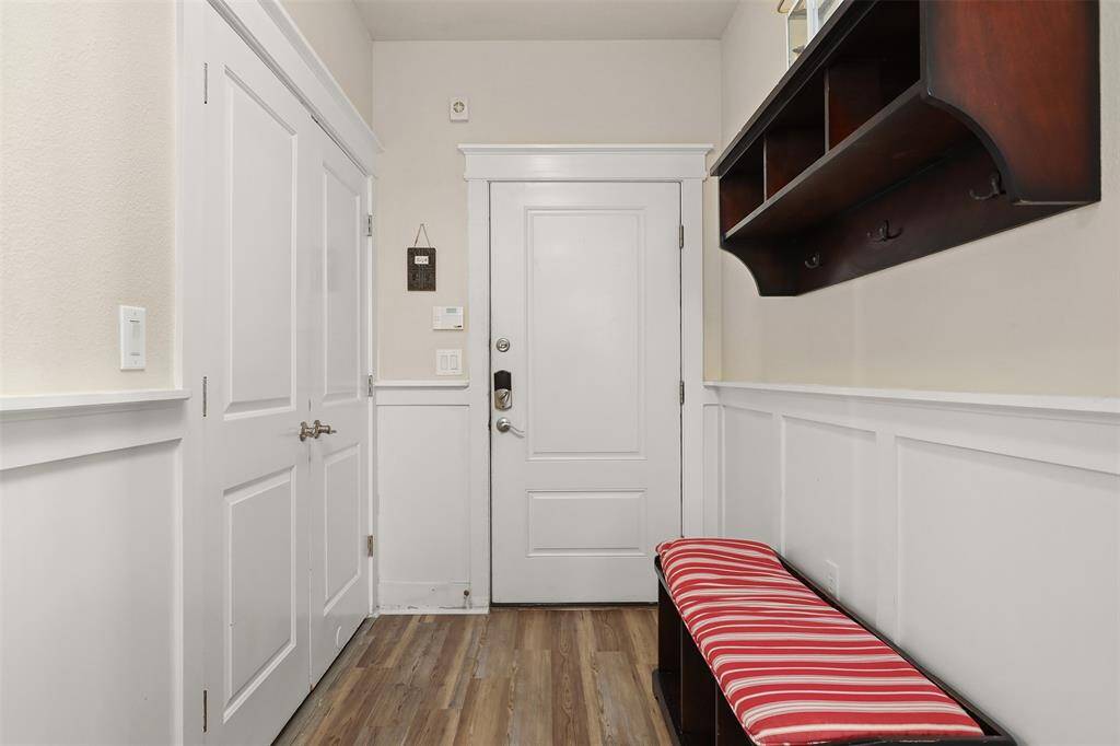 Welcome home to this charming foyer, designed for both style and practicality. The coastal decor sets a welcoming tone, featuring built-in storage and nautical accents.