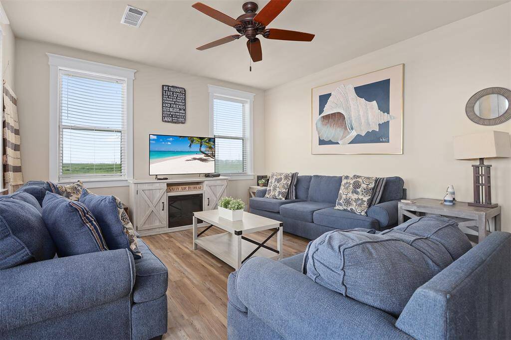 The cozy seating area featuring plush sofas is perfect for relaxation and entertainment. Enjoy your favorite shows on the modern flat-screen TV or unwind with a book in the tranquil setting.