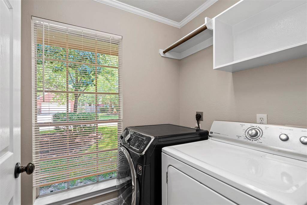 Utility room right off of breakfast area! There is now a new black dryer replacing the white one!