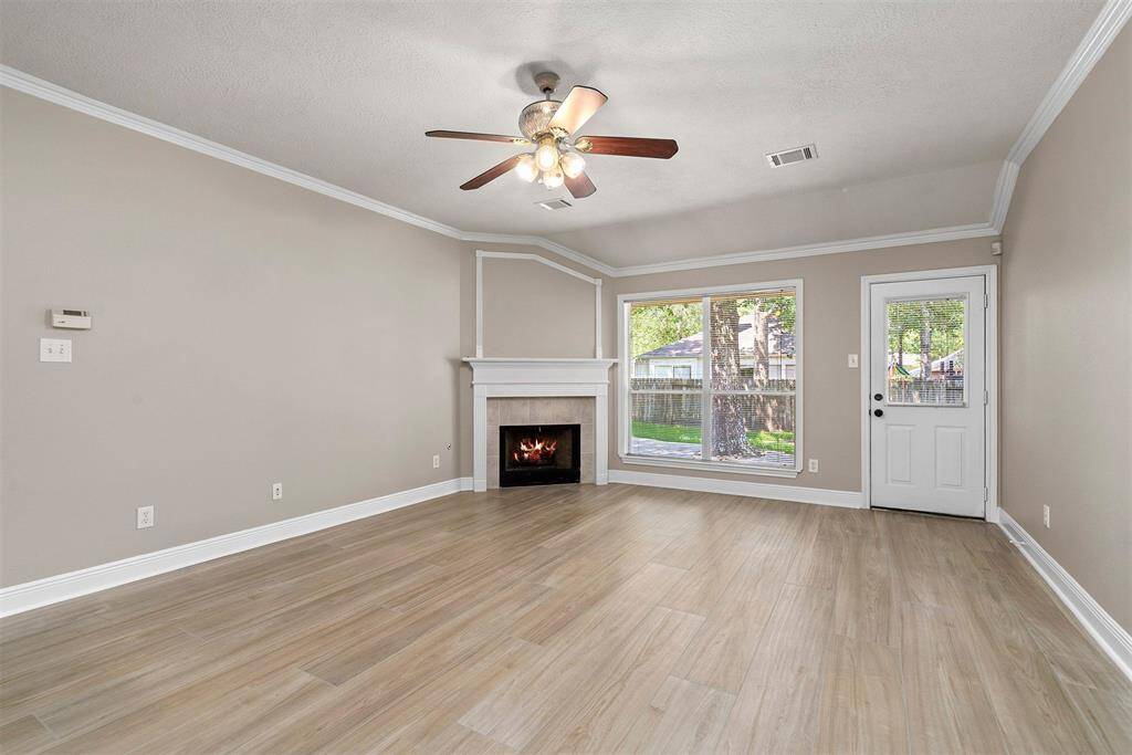 Family room with gas fireplace and large windows looking into backyard!