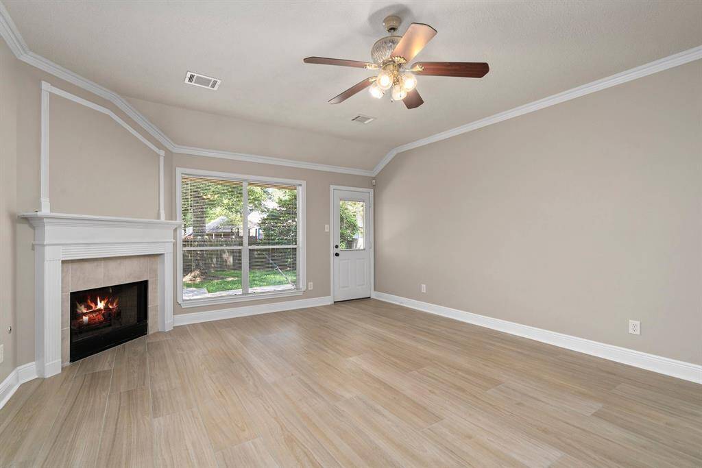 Family room with ceiling fan and crown molding!