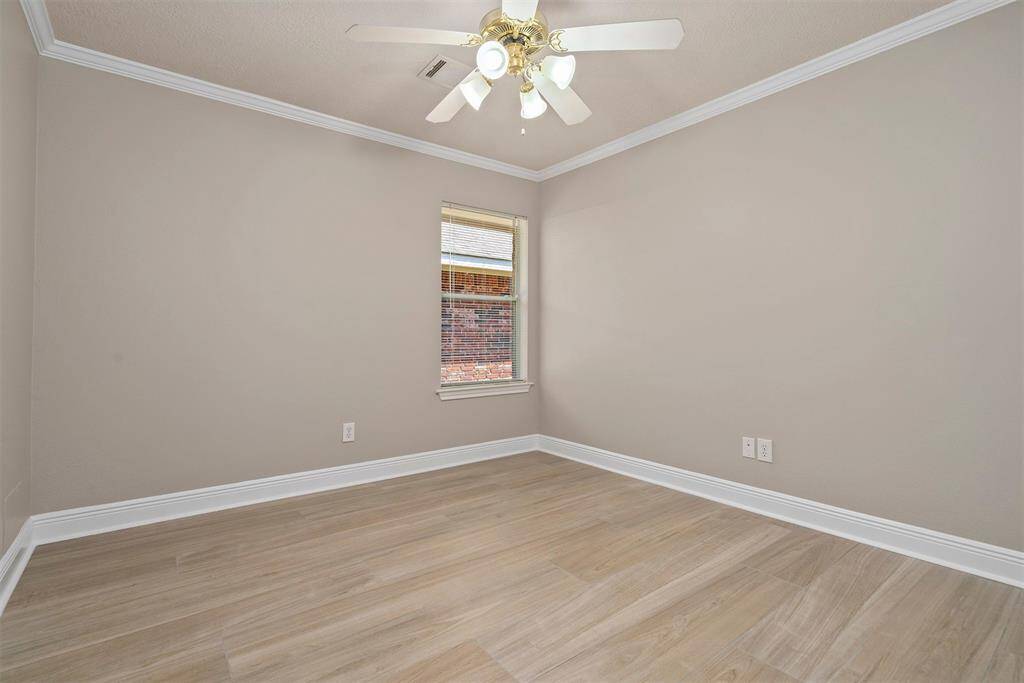 Second bedroom with ceiling fan and crown molding!