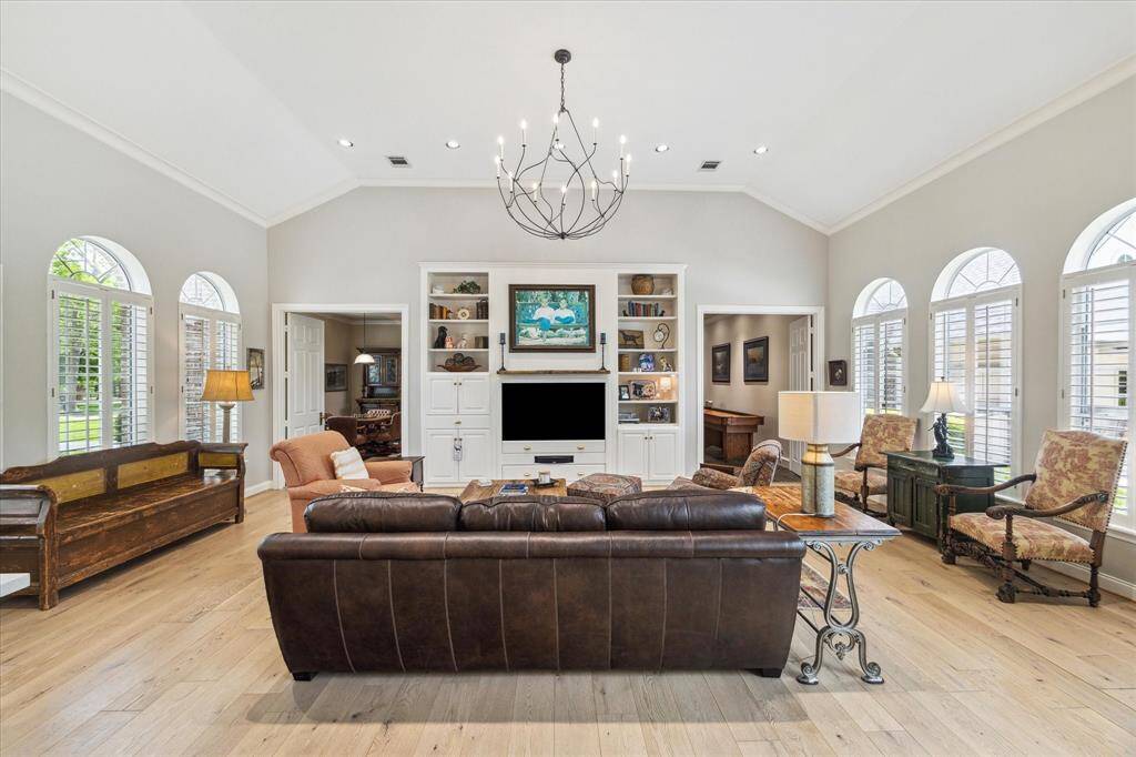 The family room is a perfect place to watch an Astros game. Recessed lighting and the custom chandelier are lit with 4000 Kelvin bulbs for a very natural glow.