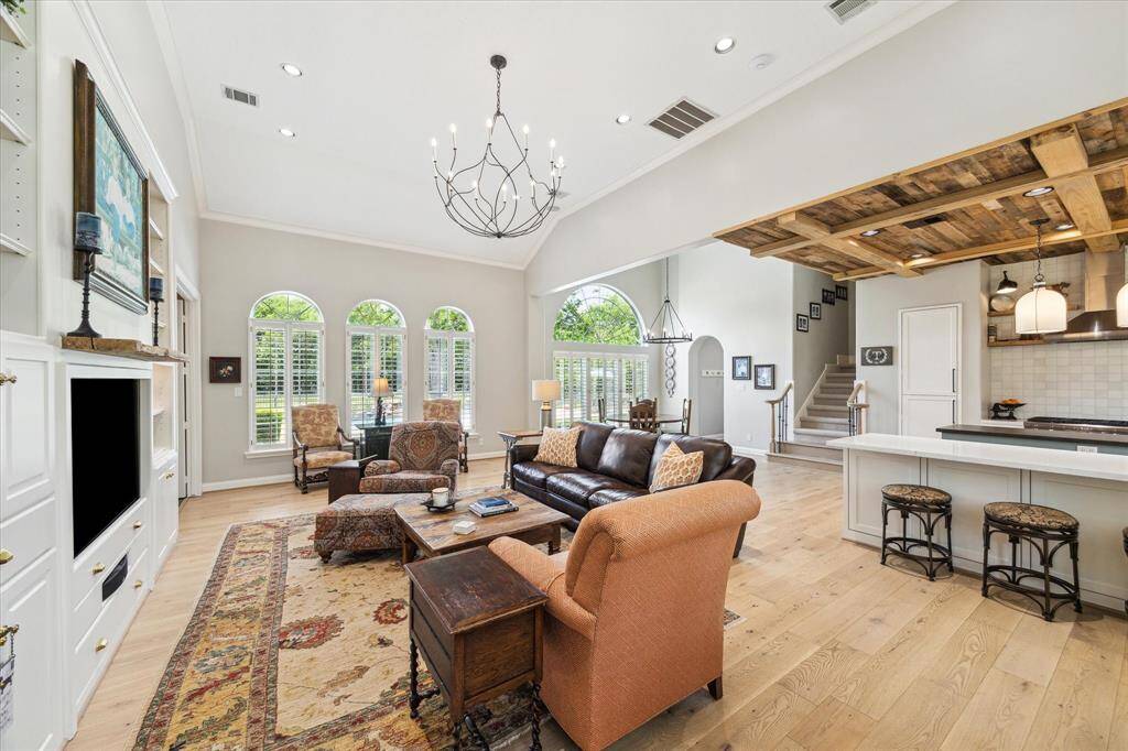 This view shows the proximity of the family room to the kitchen. The breakfast bar is a great place to pull up for a quick bite, or to engage in some lively conversations with the chef.