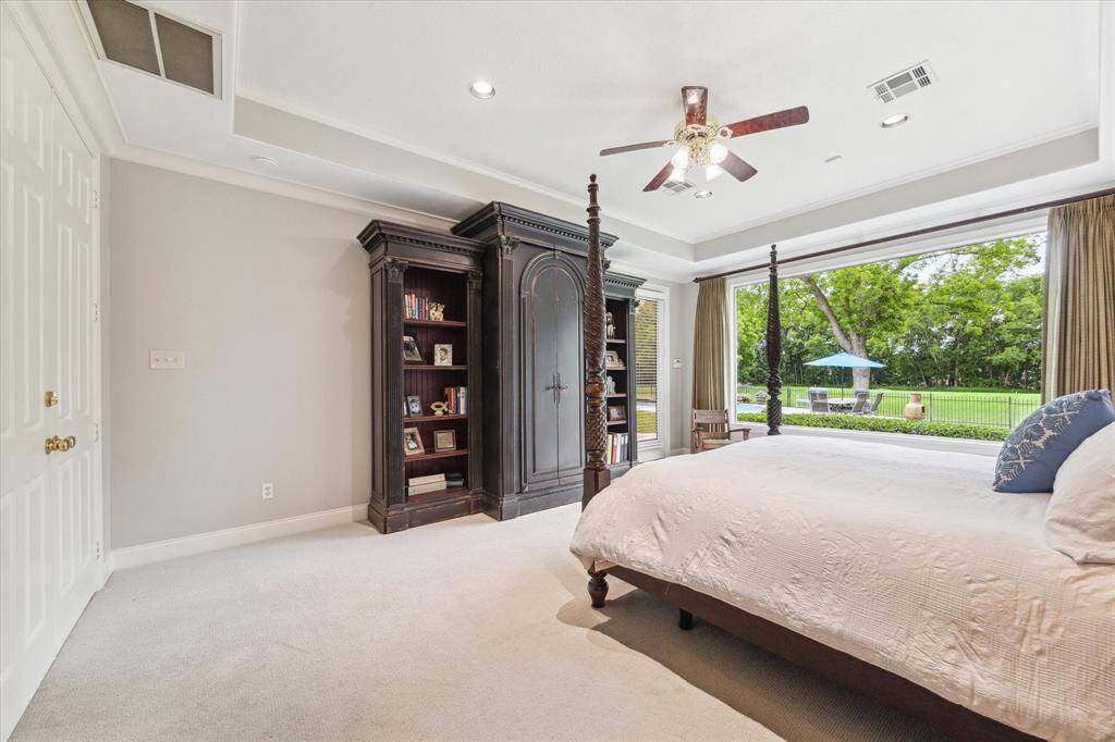 This space has plenty of room for large pieces of furniture. To the right of the armoire is a door that leads to a screened in porch where you can keep an eye on any pool activity, or enjoy a sunset.