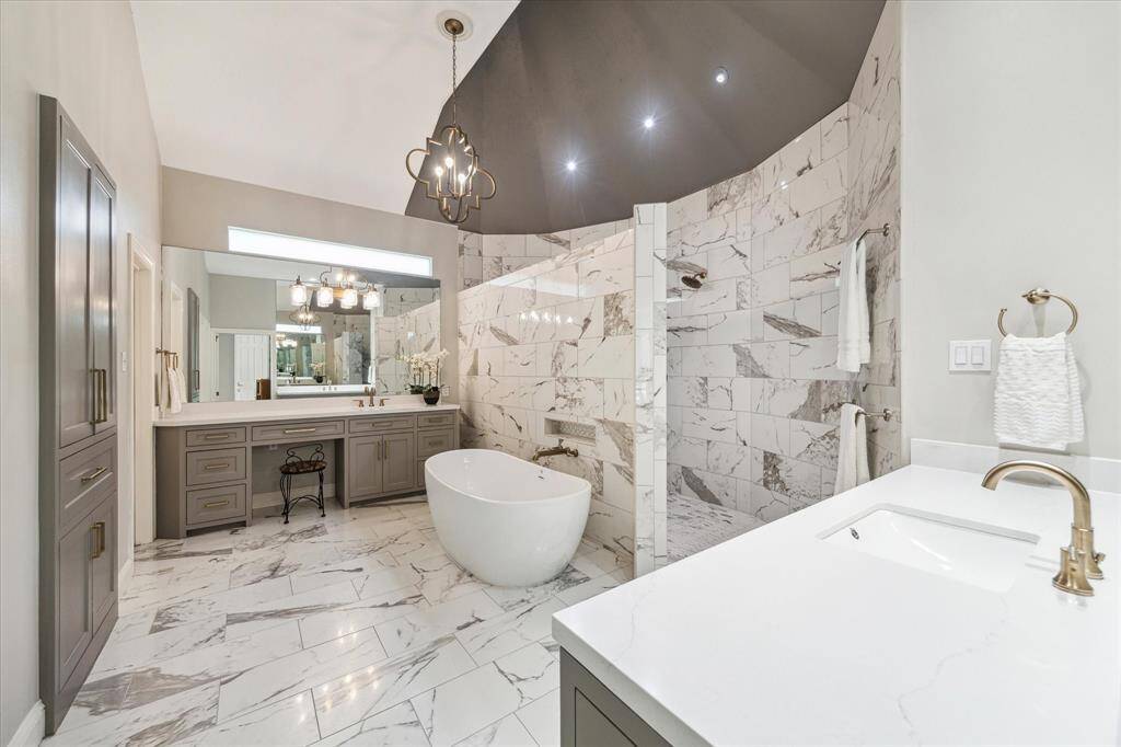 The main bathroom was completely renovated. New flooring, cabinets, fixtures, lighting, mirrors, countertops, tile, window, tub, toilet and exhaust fan over the shower area.