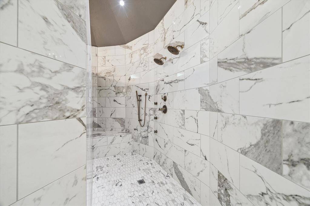 It's difficult to describe the size of this shower, but there are multiple shower heads and sprays for your enjoyment.