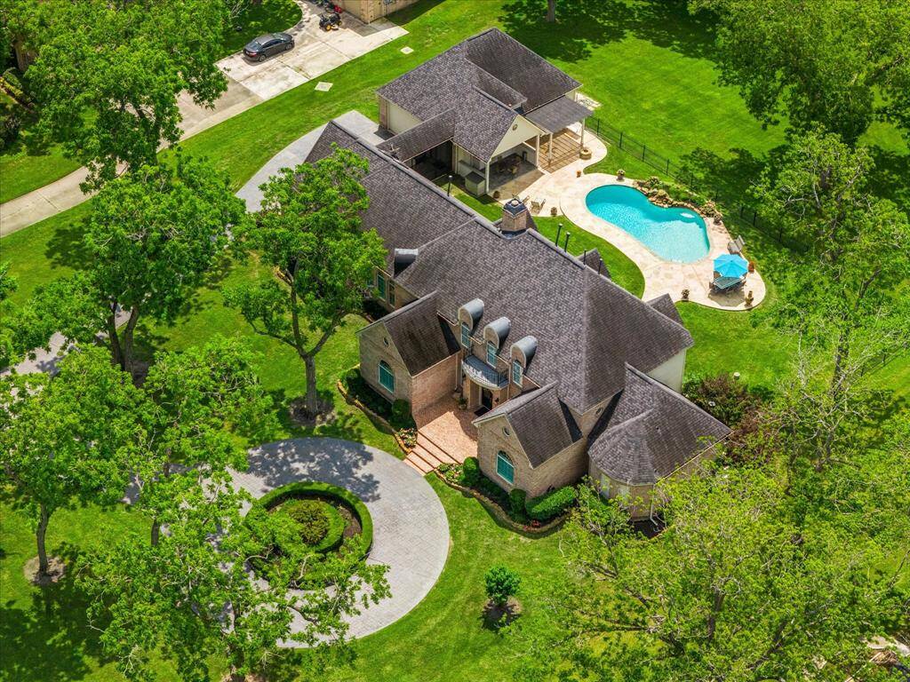 The property includes a large, detached 4 car garage with a workshop, and an air conditioned, steel beam reinforced room perfect for a weight room or man cave.