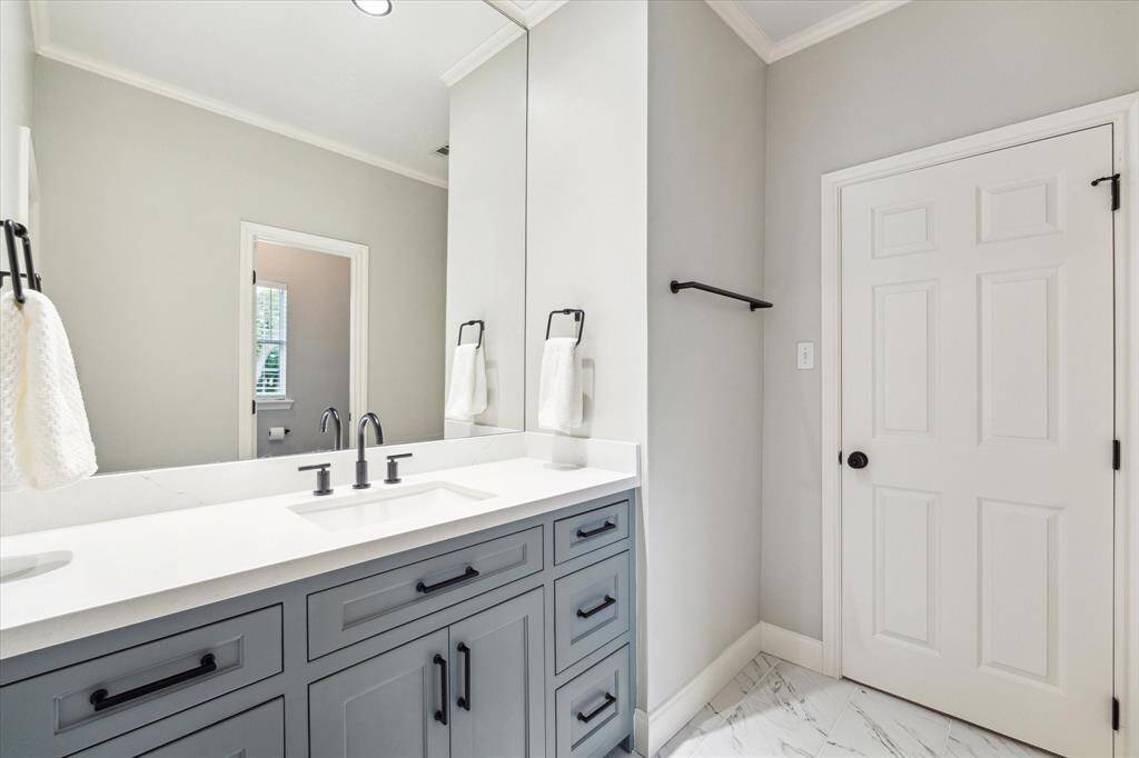 This bathroom is situated between two of the bedrooms. The toilet and shower/tub combination are closed off for privacy.