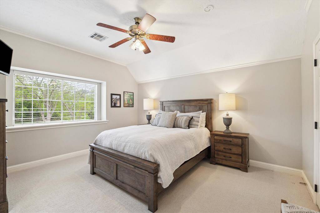The bedroom has a very nice ceiling height and large window.