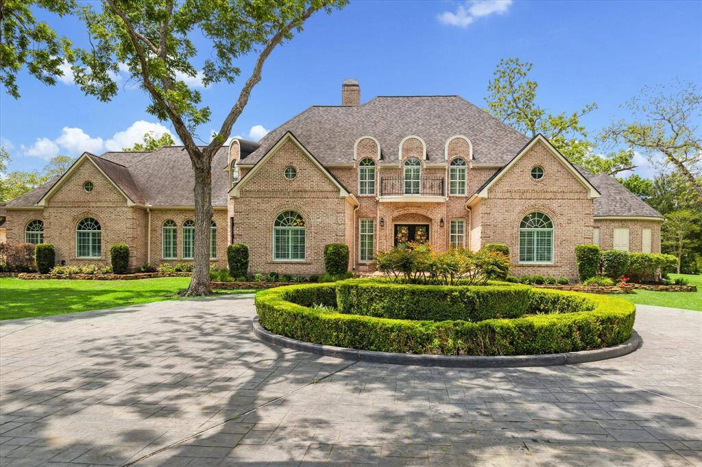 This circular drive will hold many vehicles or serve as the perfect drop off location for your many large gatherings.The driveway is stamped concrete for added interest.