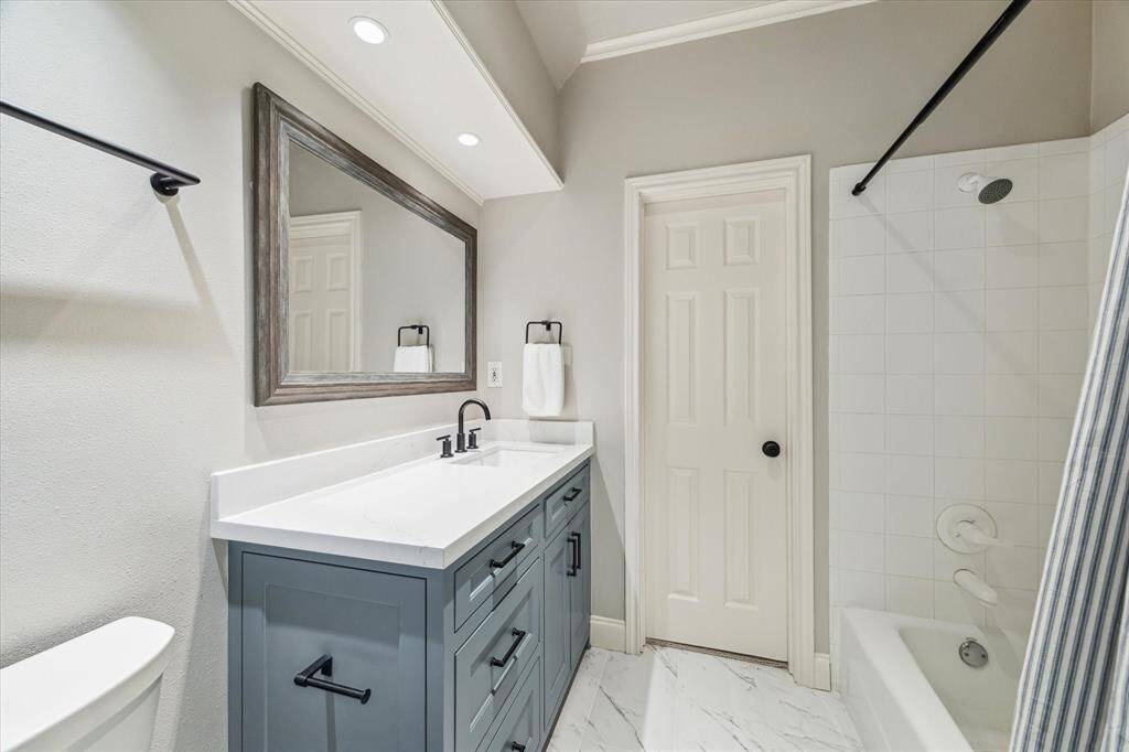 This bathroom is adjacent to the large front bedroom and the media room.
