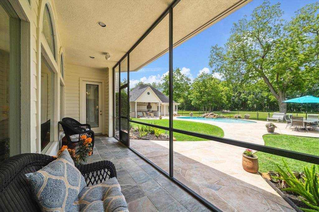 The screened in porch is located between the breakfast area and the primary bedroom.