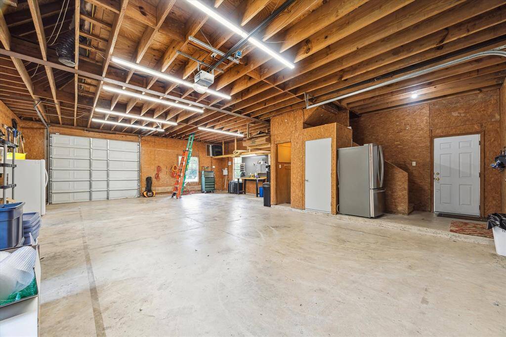 The garage can hold at least for vehicles. There is a work bench, a urinal. and extra storage upstairs adjacent to the fitness room. Two garage doors allow for air flow when working in this space.