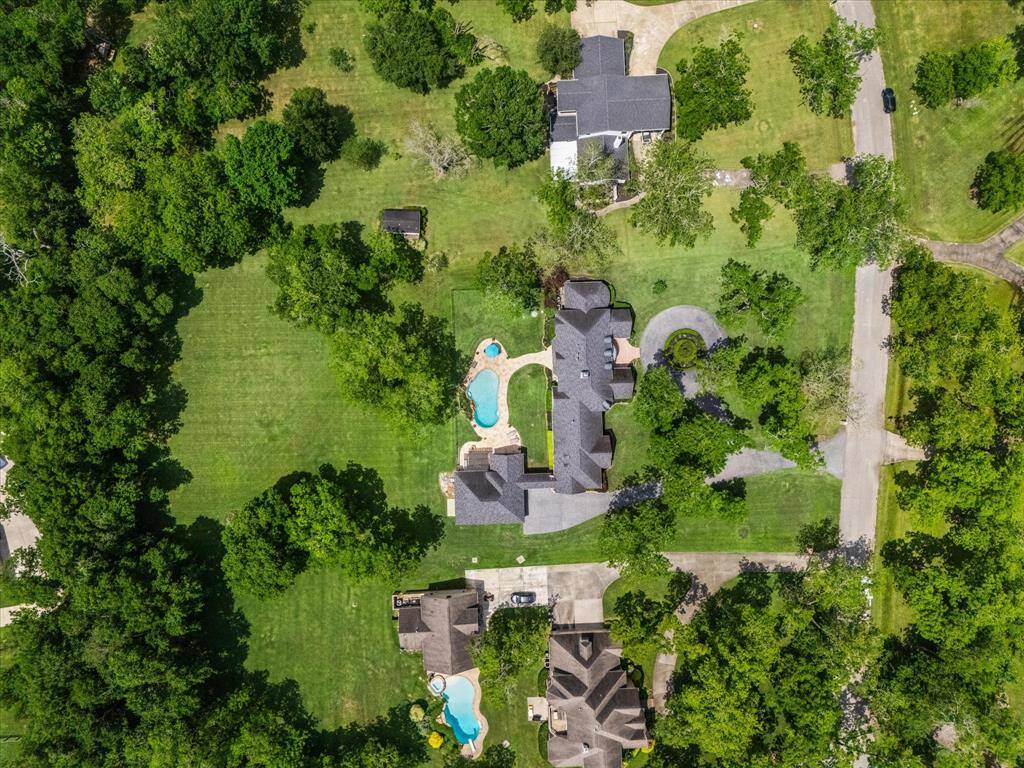The lot goes from the road on the right to beyond the row of trees (left) on the back side of the property.