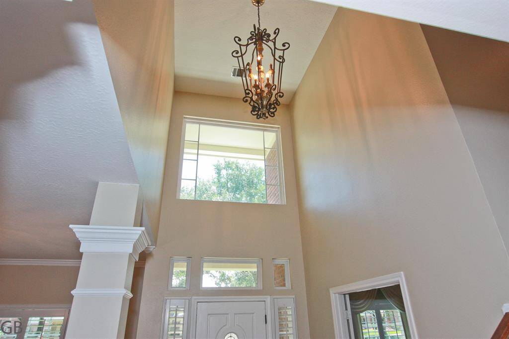 Foyer with high ceiling and abundant light.