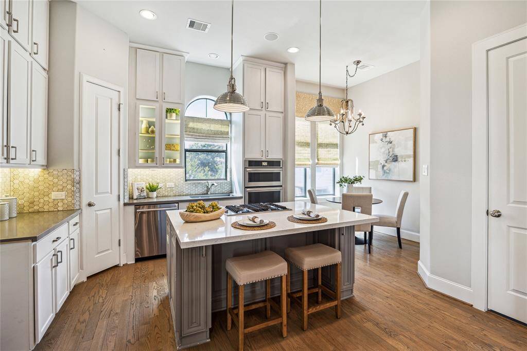 KITCHEN.   Enjoy more green views in the sunny kitchen.  Quartz countertops and stainless steel appliances.