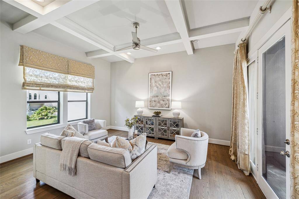 Note the details such as real hardwood floors, wood ceiling beams, custom lighting and drapes.