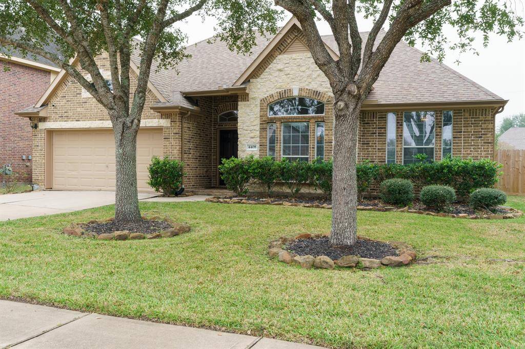 The large windows and arched doorway add elegance to the facade.