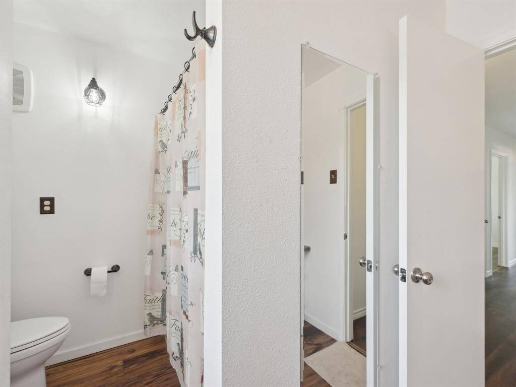 The upstairs bathroom has a tub/shower combination and a full length mirror.