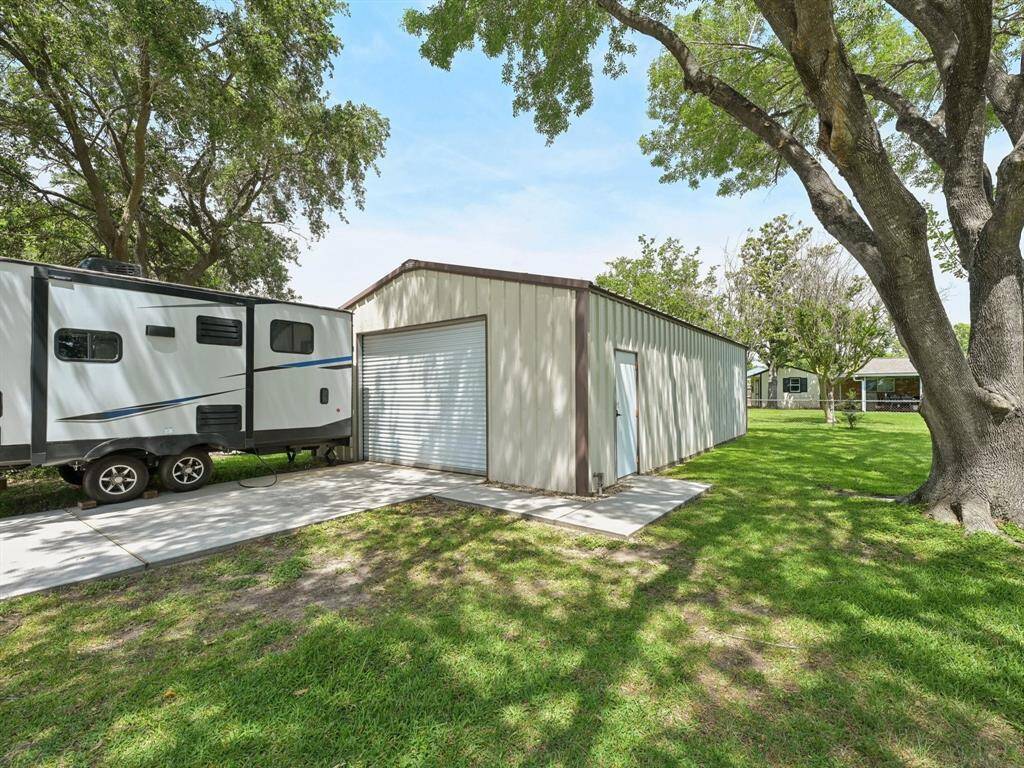 There is parking for an RV just outside of the workshop.
