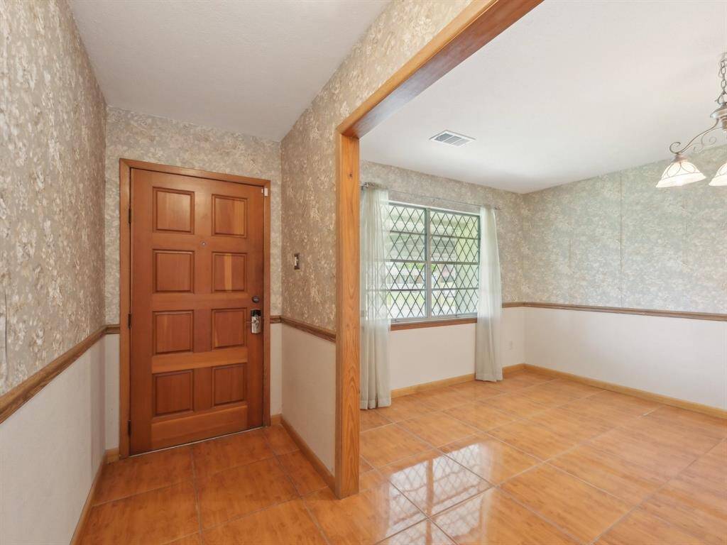 The entry has tile flooring that extends into the adjacent Formal Dining room.