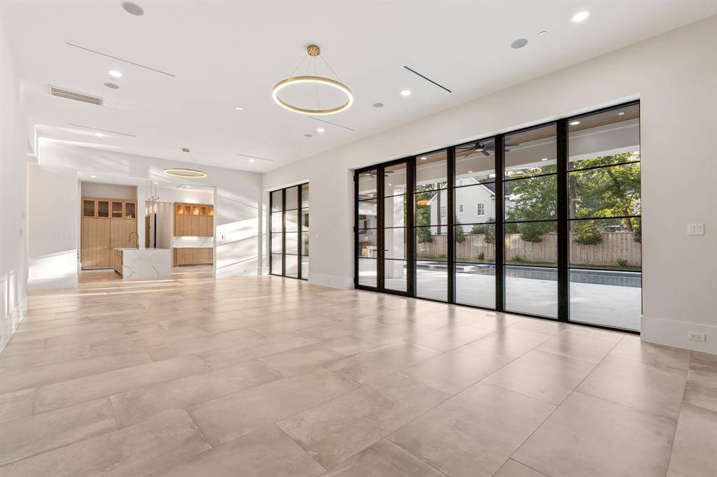 Along the rear of the home, the 40-foot-long family room is sure to become a favorite gathering place thanks to its mesmerizing pool views, fireplace and direct access to the backyard.