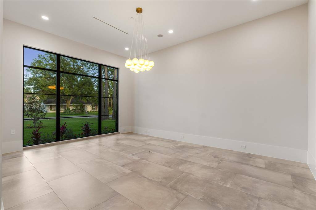 This main-floor study delivers a wonderful work-from-home destination filled with picturesque east-facing views, designer lighting and a convenient in-floor electrical outlet.