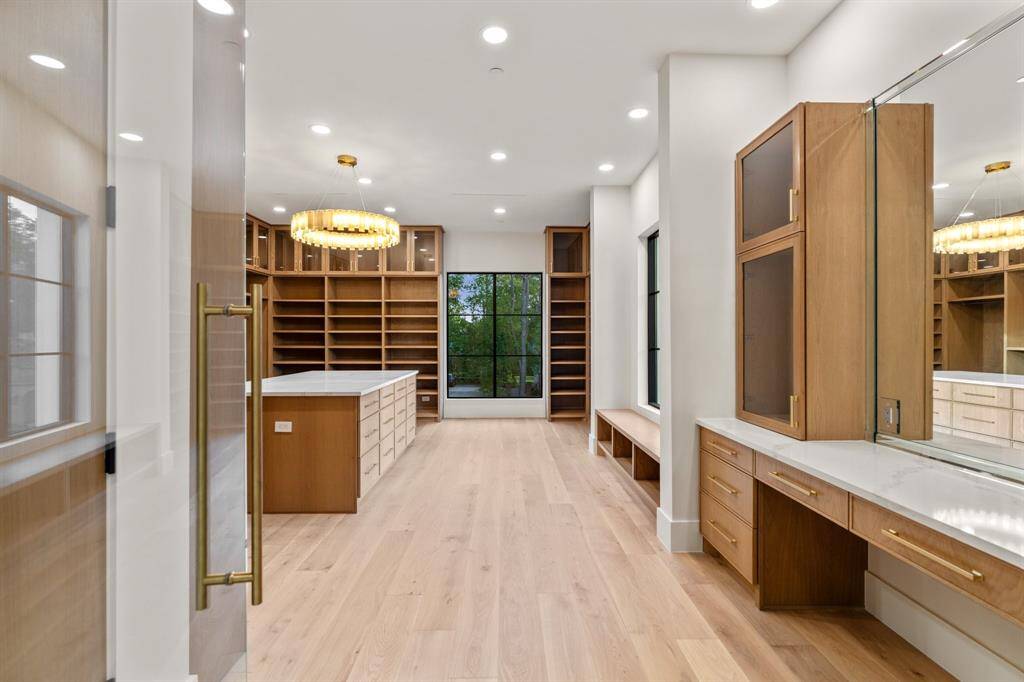 Northern and eastern exposures grace the huge primary closet, where a window seat and seated vanity area invite you to relax and take your time.