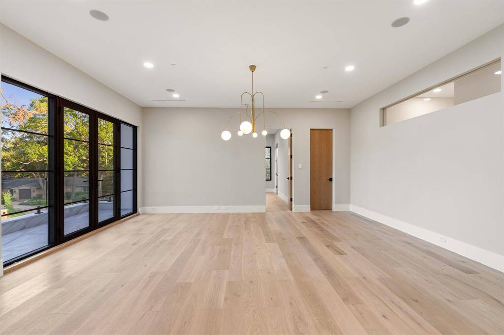 The game room boasts a lovely chandelier, a wall of east-facing windows, a balcony and clerestory windows along the mezzanine.