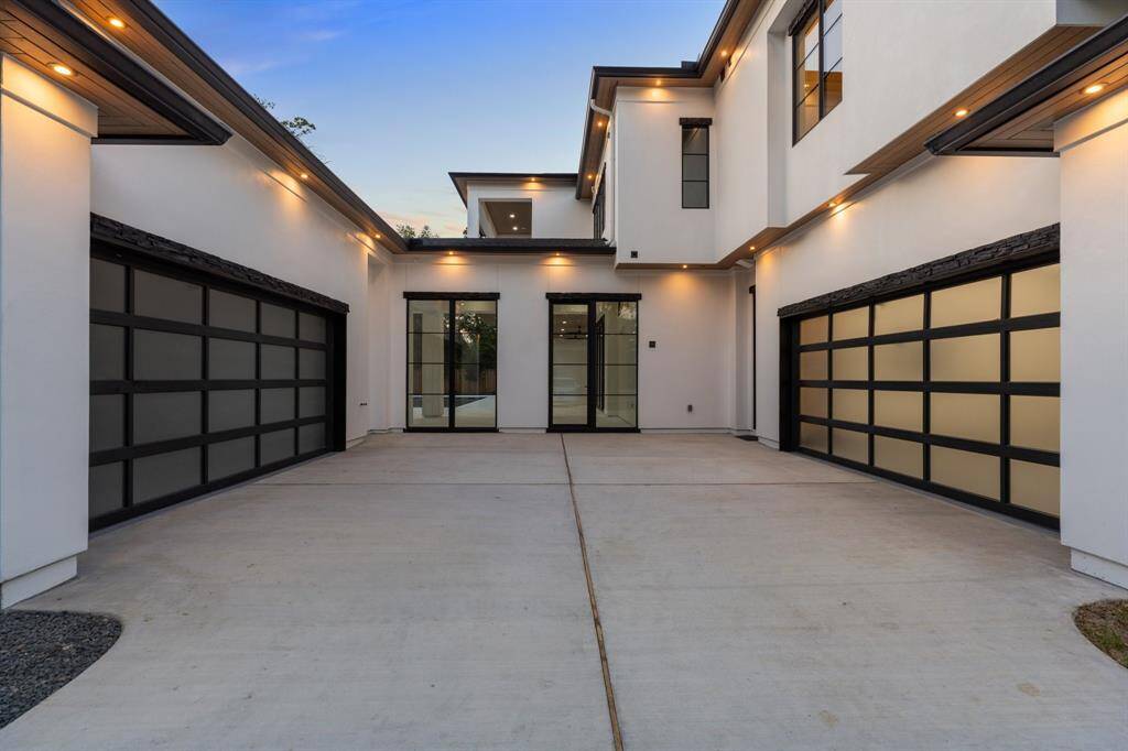 A large motor court flanked by two separate two-car garages provides ample off-street parking.