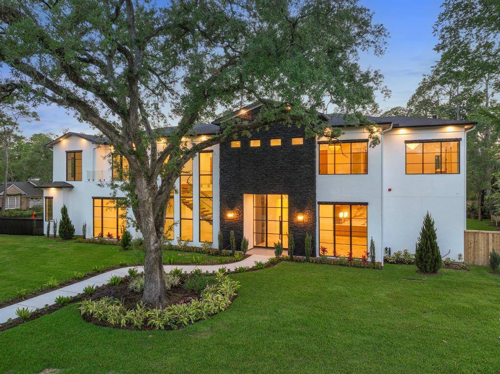 Manicured irrigated landscaping and a commanding modern façade add magnetic curb appeal to this pristine luxury abode.