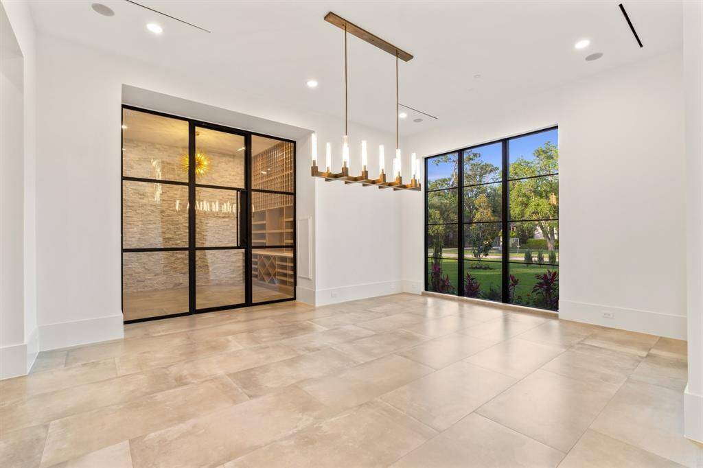 Plan your next dinner party under designer lighting in the beautiful dining room flanked by east-facing windows and a spectacular, temperature-controlled wine room.