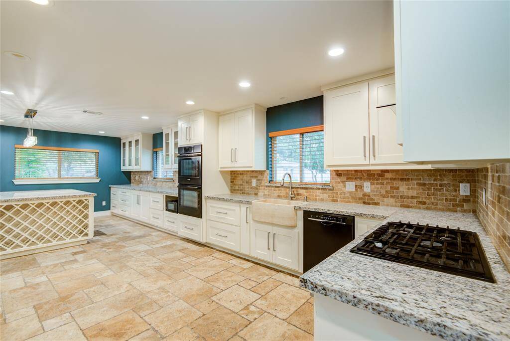 Natural stone backsplash, stone kitchen sink, built in wine rack!