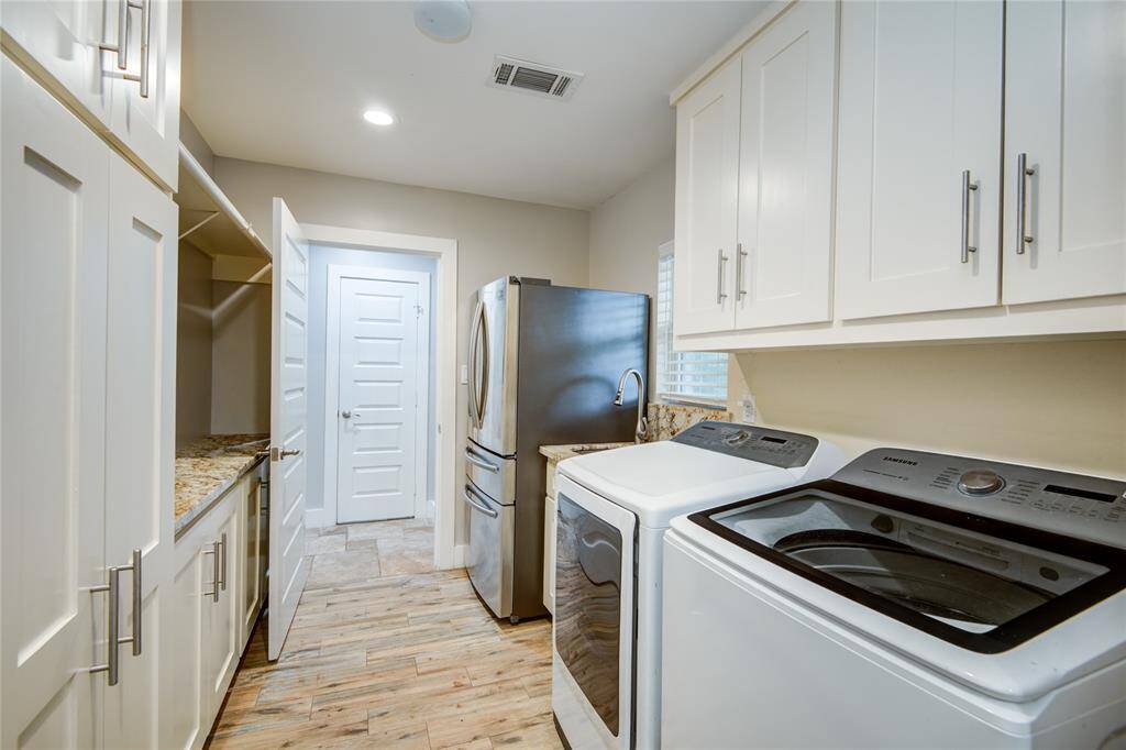 Laundry room, sink, 2nd fridge, storage, & door to 3rd bathroom