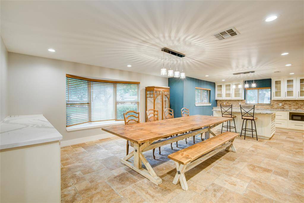 Versailles laid travertine throughout living spaces & kitchen