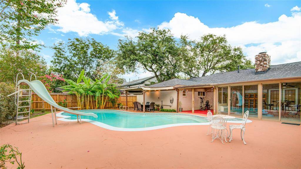 Back yard boasts pool w/ over 12ft deep end